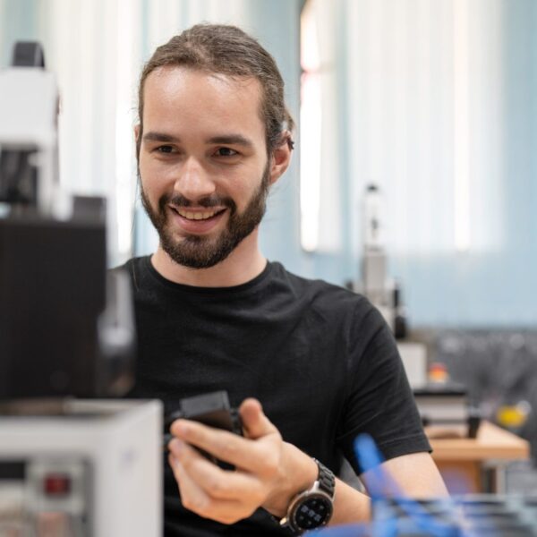 Male engineertraining design and programable AI robot arm model in academy robotics automation laboratory room for using in manufacturing or industry