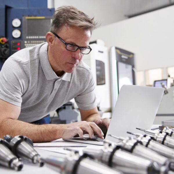 Male Engineer Using CAD Programming Software On Laptop Male Engineer Using CAD Programming Software On Laptop